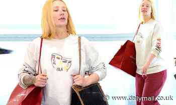 Iggy Azalea cuts a casual figure while shopping at JFK airport after arriving in NYC