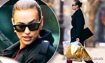Irina Shayk has her hands full of gifts as she steps out in New York City on Christmas Day