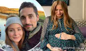 Pregnant Millie Mackintosh cradles her baby bump in emerald dress in Christmas snap