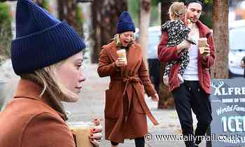 Hilary Duff bundles up while on a coffee run with new husband Matthew Koma and their daughter Banks