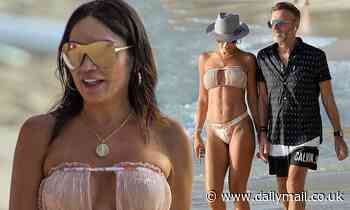 Duncan Bannatyne's wife Nigora, 39, showcases her incredible abs in a strapless bikini in Barbados