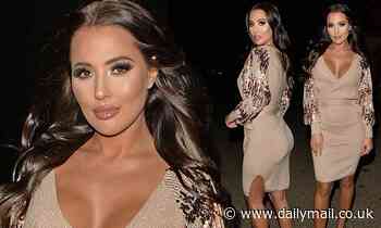 Yazmin Oukhellou puts on a busty display in a plunging champagne wrap dress