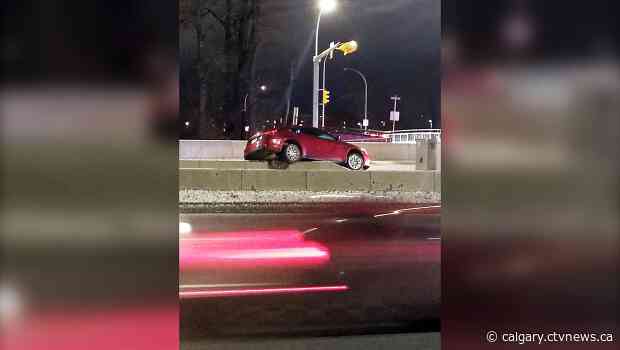 Vehicle lands on Memorial Boulevard guard rail to avoid collision
