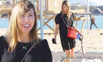 Kelly Dodd flashes a smile as she walks her dogs in Laguna Beach