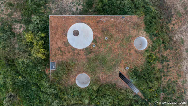 Cantilevering concrete roof emerges from Portuguese hillside house by Aires Mateus