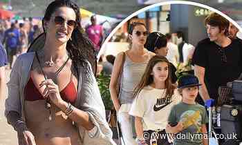 Alessandra Ambrosio rocks a red bikini on the beach before heading to the airport in Brazil