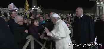 The pope apologized for slapping the hand of a woman who tried to yank him toward her