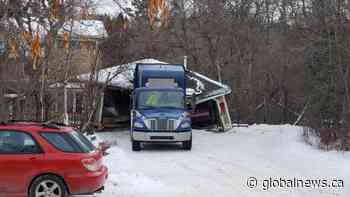 Garbage truck slams into Edmonton garage