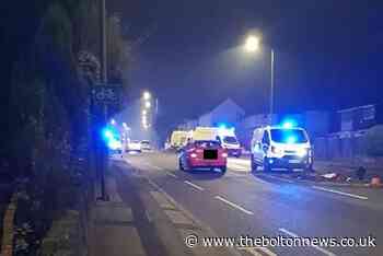 Car crashes into traffic island and garden wall