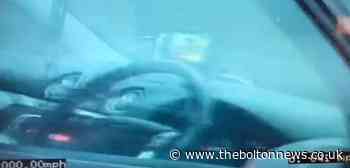 This is the moment a driver is caught watching TV on the motorway