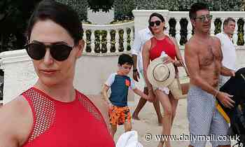 Lauren Silverman shows off her svelte physique as she joins Simon Cowell and son Eric at the beach