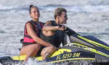 Dua Lipa reveals her pert derriere in swimsuit before heading on jet ski ride with Anwar Hadid