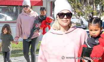 Khloe Kardashian covers up in a massive pink sweatshirt while running errands with True and Penelope