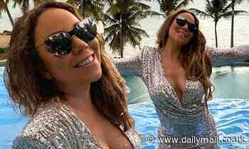 Mariah Carey jumps into hot tub while wearing designer dress