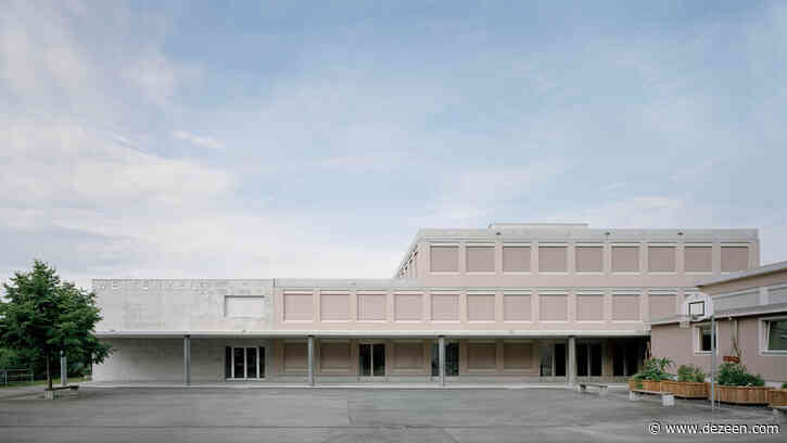 Pale pink shutters shade classrooms of a concrete school in Switzerland