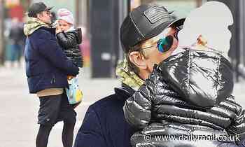 Bradley Cooper kisses daughter Lea on New York stroll... after Brad Pitt credited him for sobriety