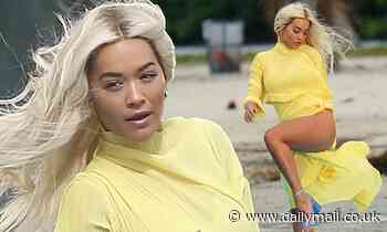 Rita Ora battles the breeze as she shoots music video in Miami in a VERY flimsy canary yellow dress