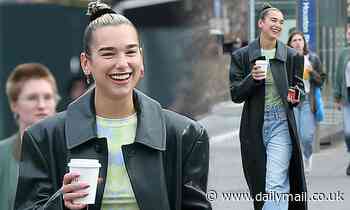 Dua Lips steps out in a forest green leather duster as she enjoys a coffee in New York