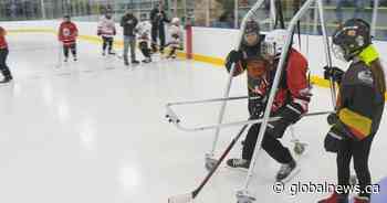 Regina hockey player with physical disability stands up on skates for first time
