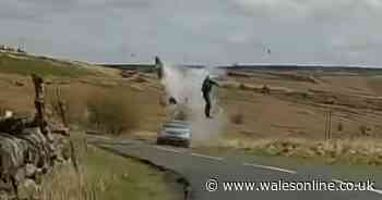 The horrific moment biker is catapulted into the air in head-on crash
