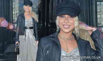 Gabby Allen cuts a quirky figure in a silver dress and baker boy hat