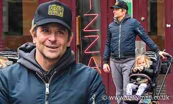 Bradley Cooper struggles to wipe the smile off his face following Oscar nomination