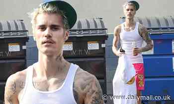 Justin Bieber shows off his toned and tattooed arms as he leaves dance practice