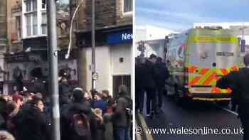 Football fans screaming 'we do what we want' and throwing toilet paper occupy Newport city centre street