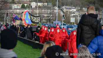 Red robed protesters hold huge funeral procession through the middle of Swansea
