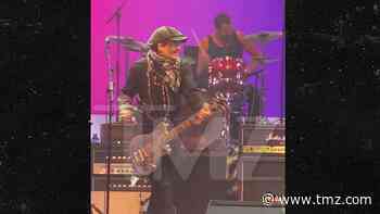 Johnny Depp Jams on Guitar During High School Charity Concert