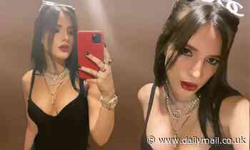 Bella Thorne models a plunging black top during night on the town