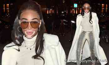 Winnie Harlow looks glam in faux snakeskin trousers and boots as she arrives at her hotel in Paris