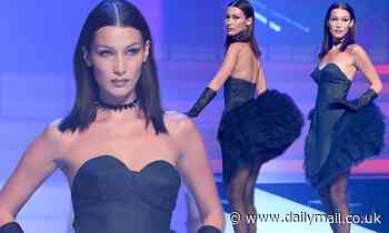 Bella Hadid smoulders in a ruffled minidress and sheer tights