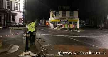 Man arrested and two people in hospital after car crashes into shop