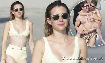 Emma Roberts playfully wraps her legs around a male friend while hitting the beach in Punta Mita
