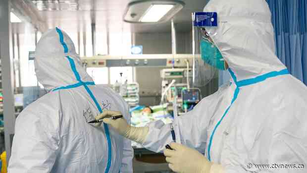 Video appears to show bodies covered by sheets in crowded Wuhan hospital hallway