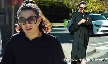 Charli XCX is effortlessly chic in a black midi dress as she steps out in LA