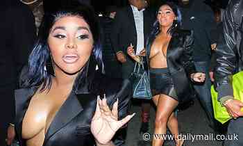 Lil Kim leaves little to the imagination in a black satin blazer as she attends Grammys afterparty