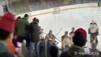 Junior hockey coach caught on video swinging stick at fan says he was protecting his players
