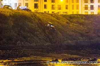 Pictured: Car plunges down embankment at Northern Ireland beach