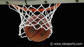 High school player sinks miracle half-court shot while falling out of bounds