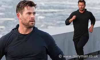 Chris Hemsworth flaunts rippling muscles in skin-tight black jumper in New York - Daily Mail