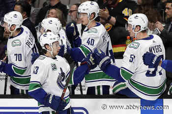 Hughes nets OT winner as red-hot Canucks beat Islanders 4-3