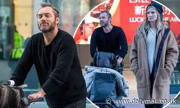 Jude Law dresses for comfort as he arrives back in London with wife Phillipa Coan