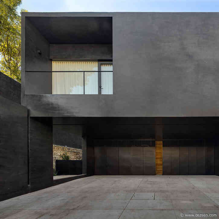 Black facades contrast pale interiors in Lluvia house by PPAA