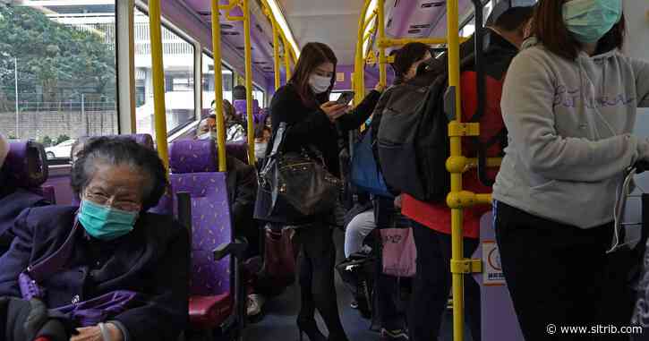 Hong Kong reports virus death as workers strike at hospitals
