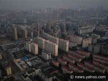 Quarantined Wuhan residents shout words of support out of their high-rise apartment windows