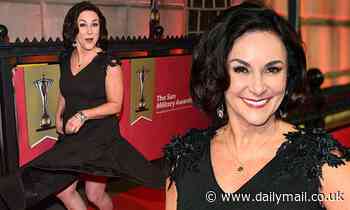 Shirley Ballas, 59, twirls across the red carpet in a shimmery black dress at the Military Awards