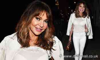 Lizzie Cundy dazzles in busty white top and skinny jeans as she attends album launch party