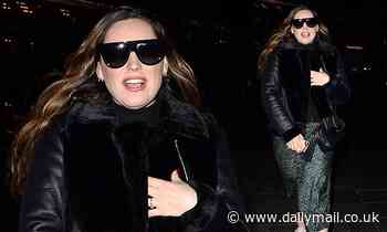 Kelly Brook puts on a stylish display in a leopard print skirt and aviator jacket as she leaves work